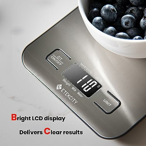Digital kitchen scale with a bowl of blueberries on top.