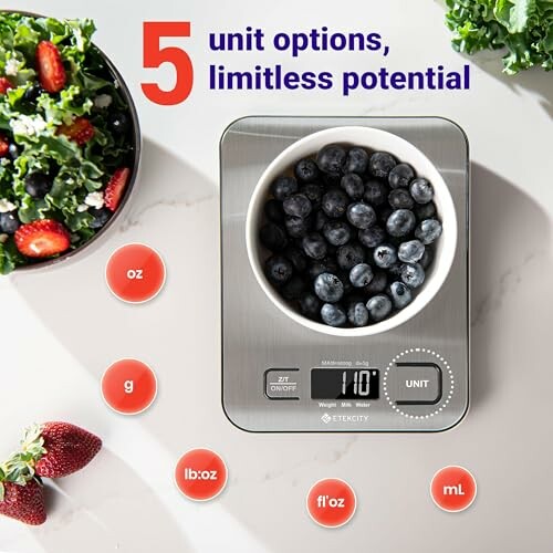 Digital kitchen scale with blueberries and salad.