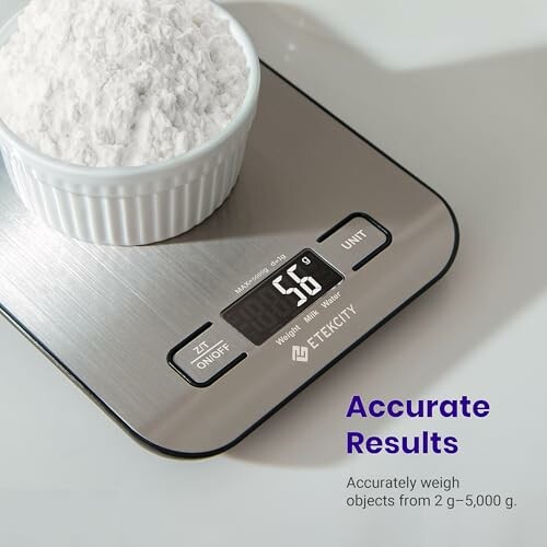 Digital kitchen scale weighing white powder in a bowl.