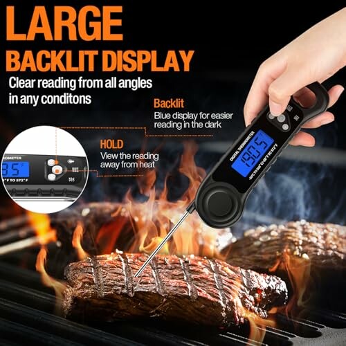Digital meat thermometer with backlit display over grilling steaks.