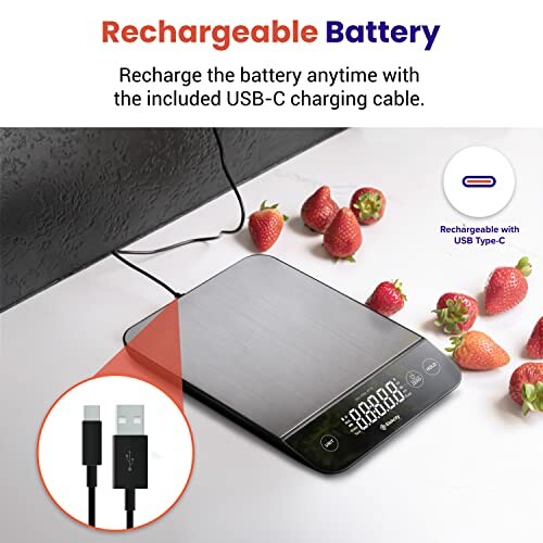 Digital kitchen scale with rechargeable battery and USB-C cable, surrounded by strawberries.