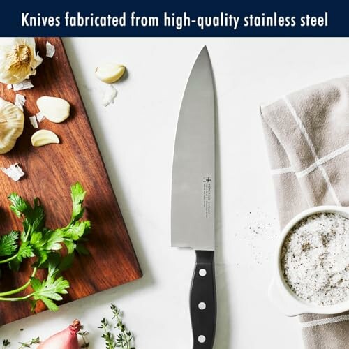A stainless steel kitchen knife with cutting board and ingredients.
